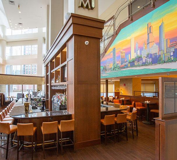 Swissotel Chicago Bar with chicago skyline mural in pastels